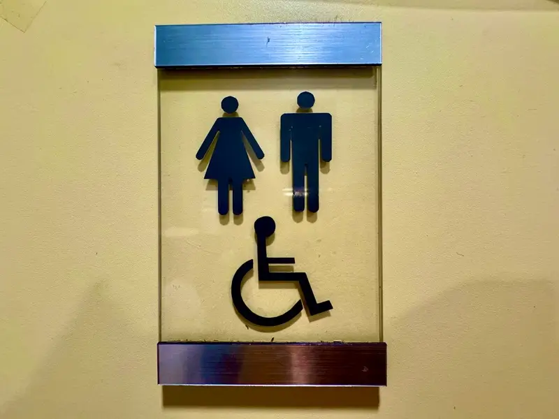 Accessible restroom with grab bars, wide space, and wheelchair-accessible features